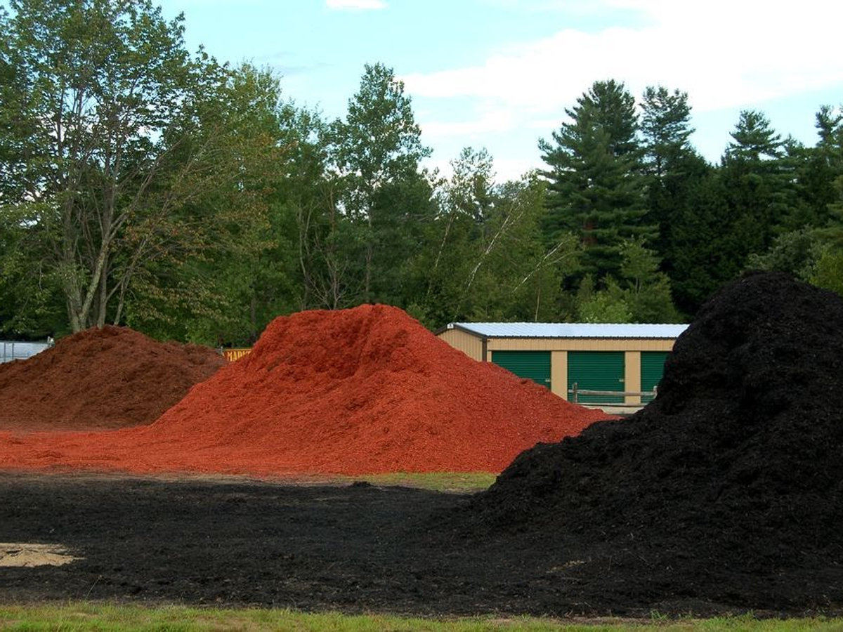 Piles of dyed hardwood mulch at the supply yard